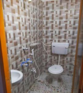 a bathroom with a toilet and a sink at The PENTHOUSSE near ION Exam Centre & Airport in Guwahati
