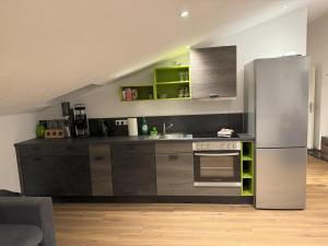 a kitchen with a stainless steel refrigerator at Schwalbennest Monteurwohnung in Korbach