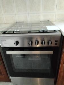 a stove top oven sitting in a kitchen at Casa da Praia in Praia de Mira