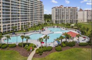 an aerial view of a pool at a resort at Stylish Barefoot Townhome, Sleeps 10 NEW! in Myrtle Beach