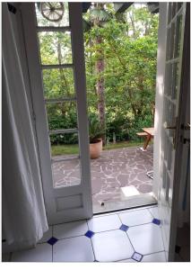 otwarte drzwi na patio z doniczką w obiekcie Mendiska w Bajonnie