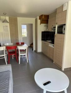a kitchen and living room with a table and chairs at Residence de la Plage Pierre et Vacances in Le Crotoy