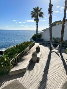 a wooden pathway with palm trees and the ocean at Santa Cruz Ocean Villa in Gaula