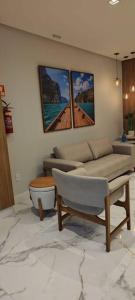 a living room with a couch and a table at Lindo apartamento em Guarapari - Novinho - Vista Maravilhosa in Guarapari