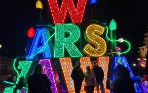 a group of people standing in front of a christmas sign at Old Town Apartment A in Warsaw