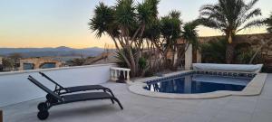 a patio with a chair and a swimming pool at Veronica Villa in Partaloa