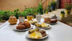a table with plates of breakfast foods on it at Guiltor host in Chachapoyas