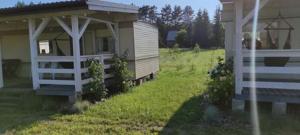 a house with a white fence next to a yard at LAWENDOVO in Nowinka