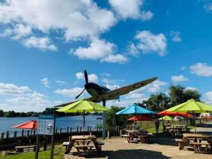 an airplane is flying over tables and umbrellas at Immaculate 3-Bed Caravan with Hot Tub in Lincoln