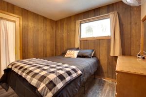 a bedroom with a bed in a room with a window at Iron River Condo with Gas Grill Near Skiing and Hiking in Iron River