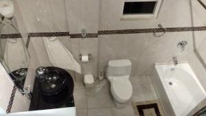 a bathroom with a toilet and a sink at Zeus Guesthouse in Grays Hill