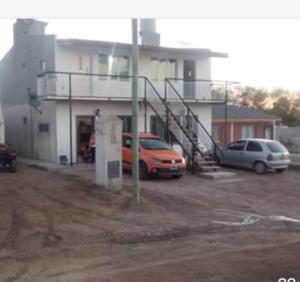 an orange van parked in front of a building at Alberto Beach in Las Grutas