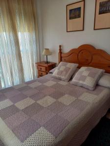 a bedroom with a purple and white checkered bed at Beachfront 3 Bedroom Family Apartment in Matalascañas