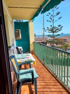 a balcony with two chairs and a table at Beachfront 3 Bedroom Family Apartment in Matalascañas