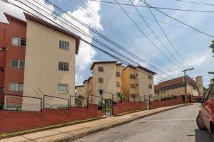 an empty street with buildings on the side at Apto c otima localizacao em Gloria, Belo Horizonte in Belo Horizonte