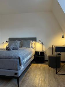 a bedroom with a large bed and a table at Studiowohnung 5 in Buxtehude in Buxtehude