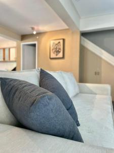 a couch with blue pillows on it in a room at CHACRAS Lodge in Mendoza