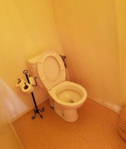 a bathroom with a white toilet in a room at Desert Berber Fire Camp in Merzouga +78 photos