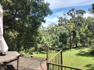 a balcony with a view of a park at La Boheme Secluded Luxury Spa Villa in Daylesford
