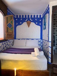 a bed in a room with blue and white at dream house sebanine in Chefchaouen