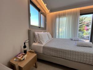 a bedroom with a bed and a large window at Maison deluxe studios and apartment in Parga
