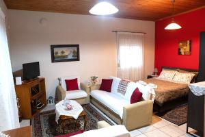 a living room with a bed and a couch at Cottage Lina in Edessa
