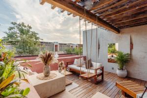 an outdoor patio with a couch and a table at Entorno Tulum - Luxury Villas in Tulum