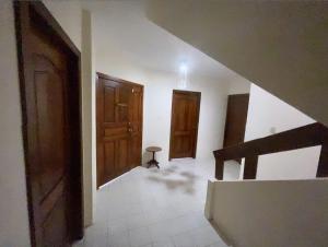 an empty room with a staircase and wooden doors at Suites- Salinas in Salinas