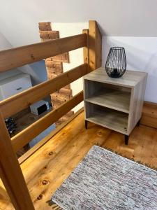 a room with a wooden staircase with a table and a rug at Apartament u Mrugały in Biały Dunajec