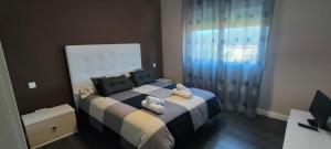 a bedroom with a large bed with two stuffed animals on it at Villa Veneziola La Manga in Murcia +15 photos