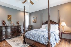 a bedroom with a canopy bed and a dresser at Tropical Oasis with Heated Pool in Boynton Beach +33 photos