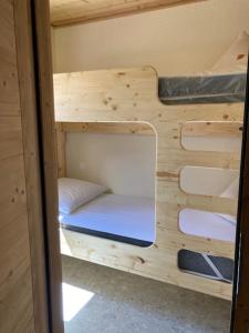 a room with two bunk beds in a cabin at TIGNES VAL CLARET A LA CONQUETE DES SOMMETS 116 in Tignes
