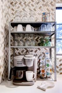 a shelf with a coffee maker and cups on it at Antlers - A Birdy Vacation Rental in San Antonio