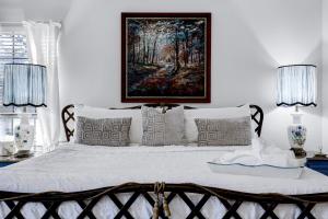 a bedroom with a bed with a painting on the wall at Antlers - A Birdy Vacation Rental in San Antonio