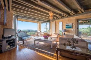 a living room with a couch and a tv at Villa Catani in Kalamaki Chanion