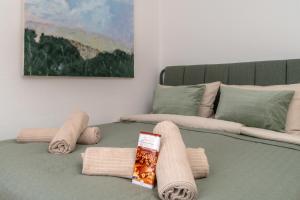 a bed with blankets and towels on top of it at NEW-Rita - atemberaubenden Wasserfälle in Triberg