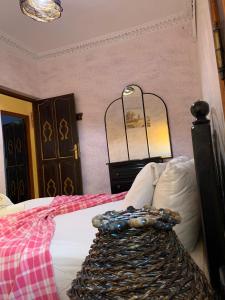 a bedroom with a bed with a dresser and a mirror at dream house sebanine in Chefchaouen