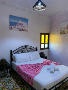 a bedroom with a bed with a cross on it at dream house sebanine in Chefchaouen