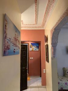 a hallway with a red door and a ceiling at dream house sebanine in Chefchaouen