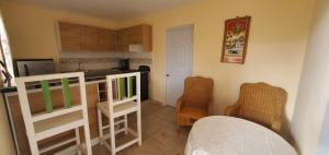 una pequeña cocina con encimera y sillas en una habitación en Apartahotel Next Nivel, en Punta Cana