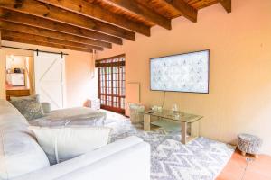 a living room with a couch and a table at Brooklyn's Holiday Home in Pretoria
