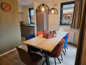 a dining room table with chairs and a box on it at New 3 bedroom house 7 people in Ewijk