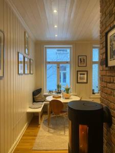 a dining room with a table and a window at Lovely two bedroom flat in central Oslo in Oslo