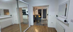 an empty room with a glass door to a kitchen at Immaculate 3-Bed House in Hull in Hull