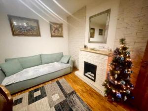 a living room with a christmas tree and a couch at Bali Apartment in Belgrade