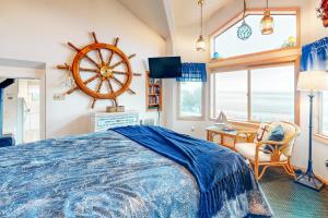 a bedroom with a bed and a steering wheel on the wall at Wave Watch `N in Oceanside