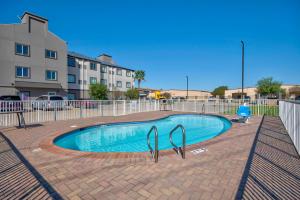 a swimming pool with a fence around it at Motel 6-Harlingen, TX in Harlingen