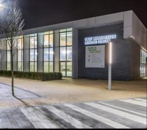 een gebouw met een bord ervoor bij Etihad Stadium, Coop Live Arena Manchester in Manchester