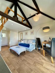 a living room with a blue couch and a table at The Granary in Braunton