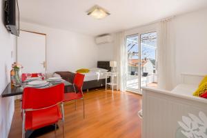 uma sala de estar com uma mesa e cadeiras e um quarto em Apartment Cable car 1 em Dubrovnik